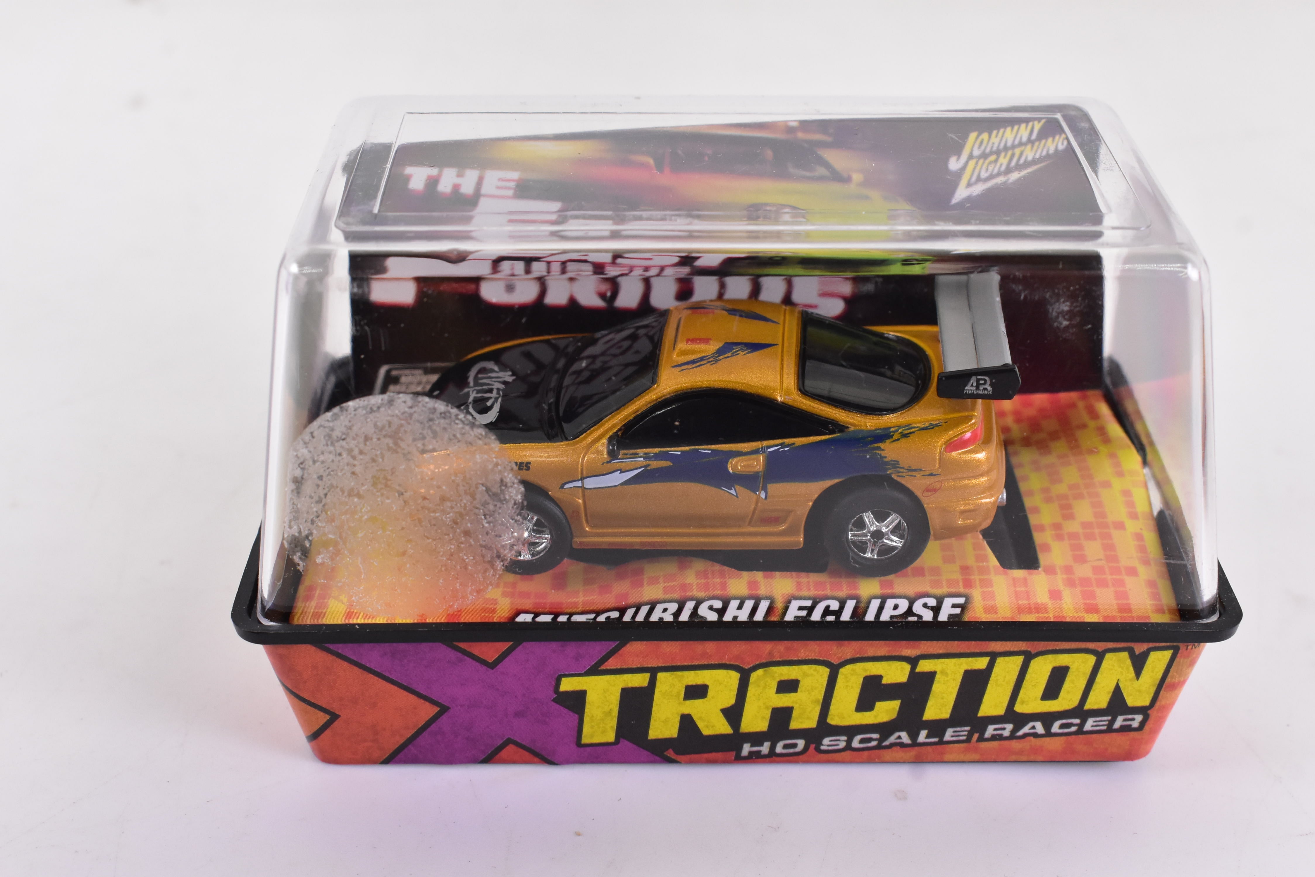 Get Your Hands on the Mitsubishi Eclipse Gold Xtraction Chassis Ho Scale Racer 501-1 by Auto World!