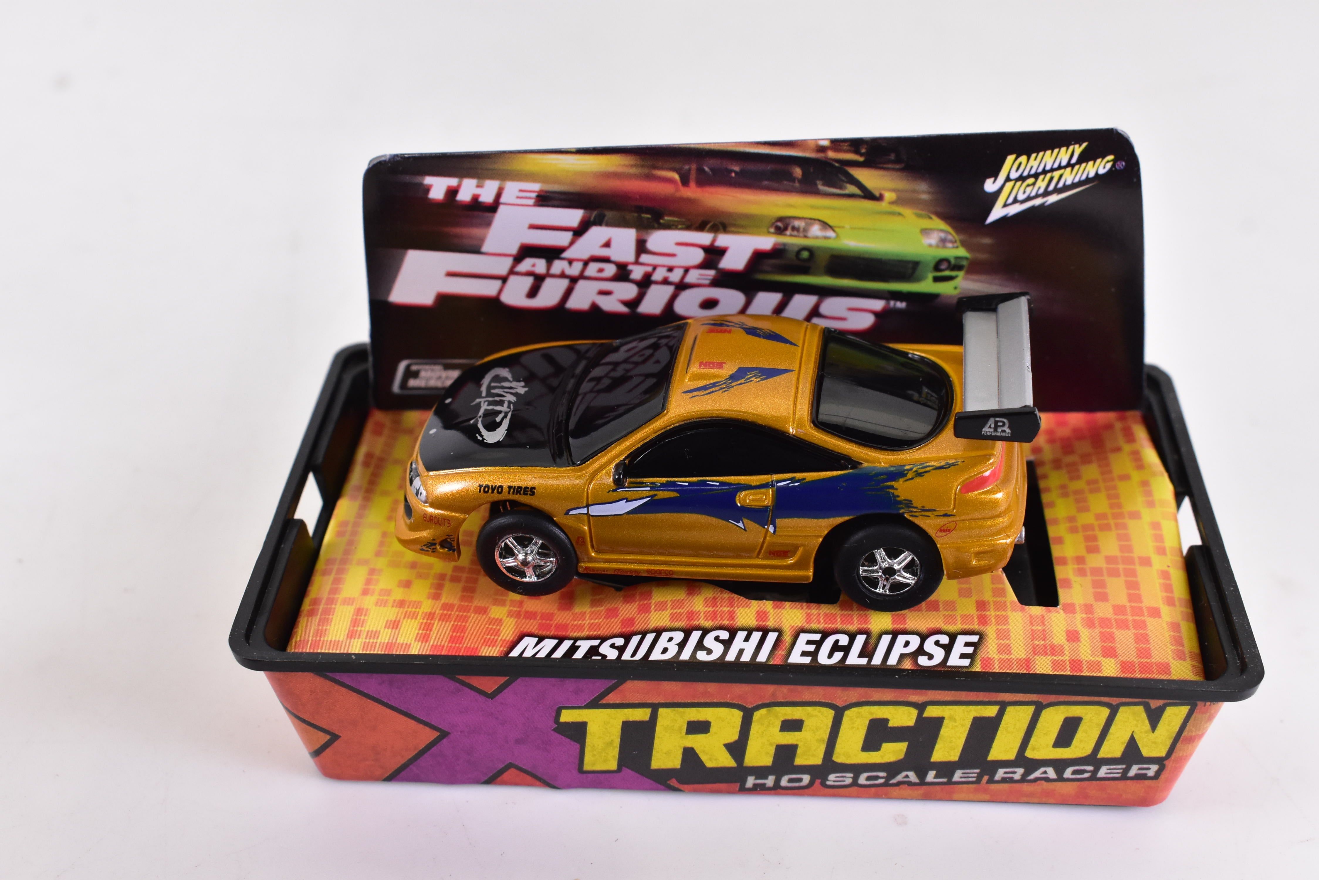 Get Your Hands on the Mitsubishi Eclipse Gold Xtraction Chassis Ho Scale Racer 501-1 by Auto World!