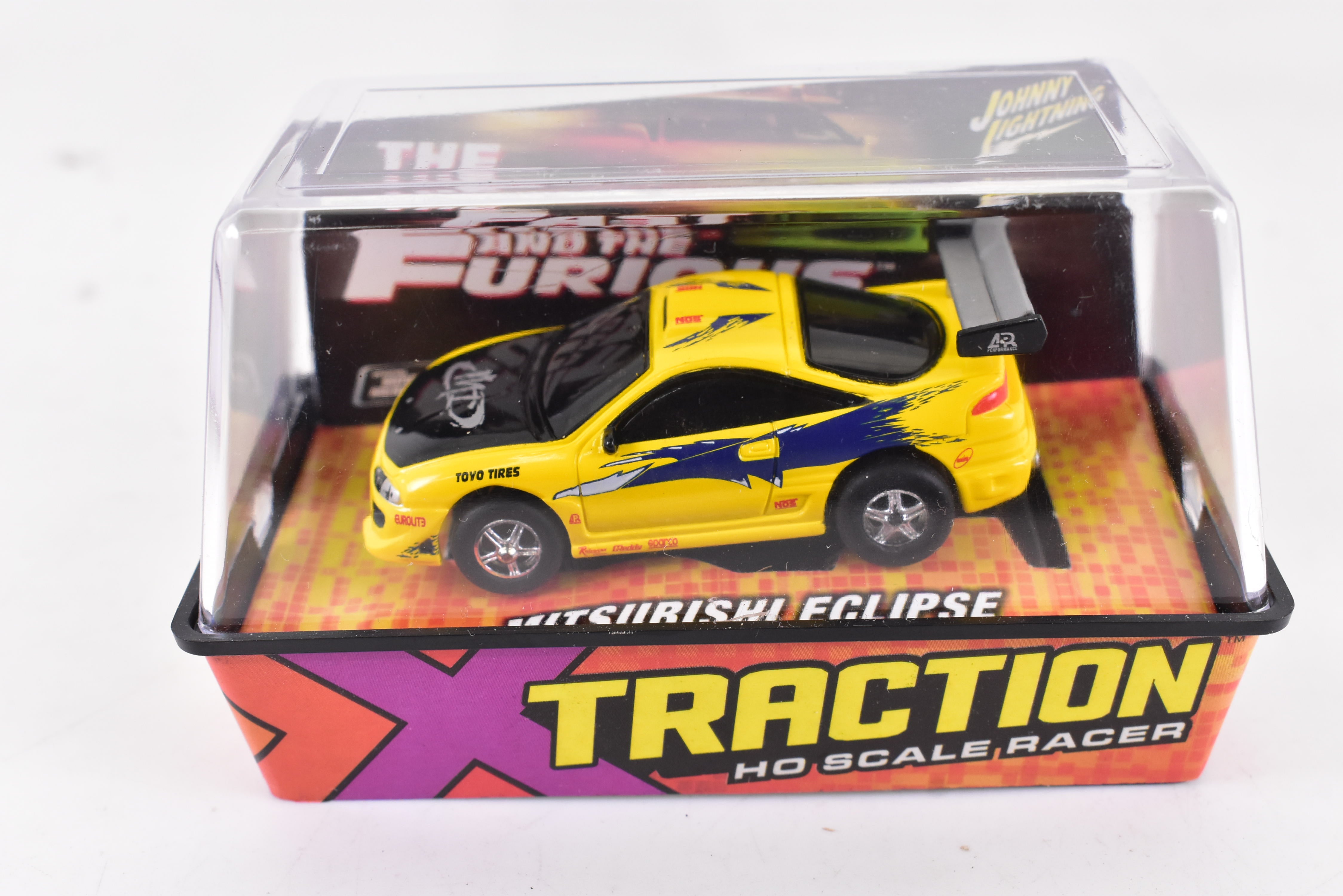 Get Your Thrills with the Stunning Yellow Mitsubishi Eclipse Ho Scale Racer by Auto World!
